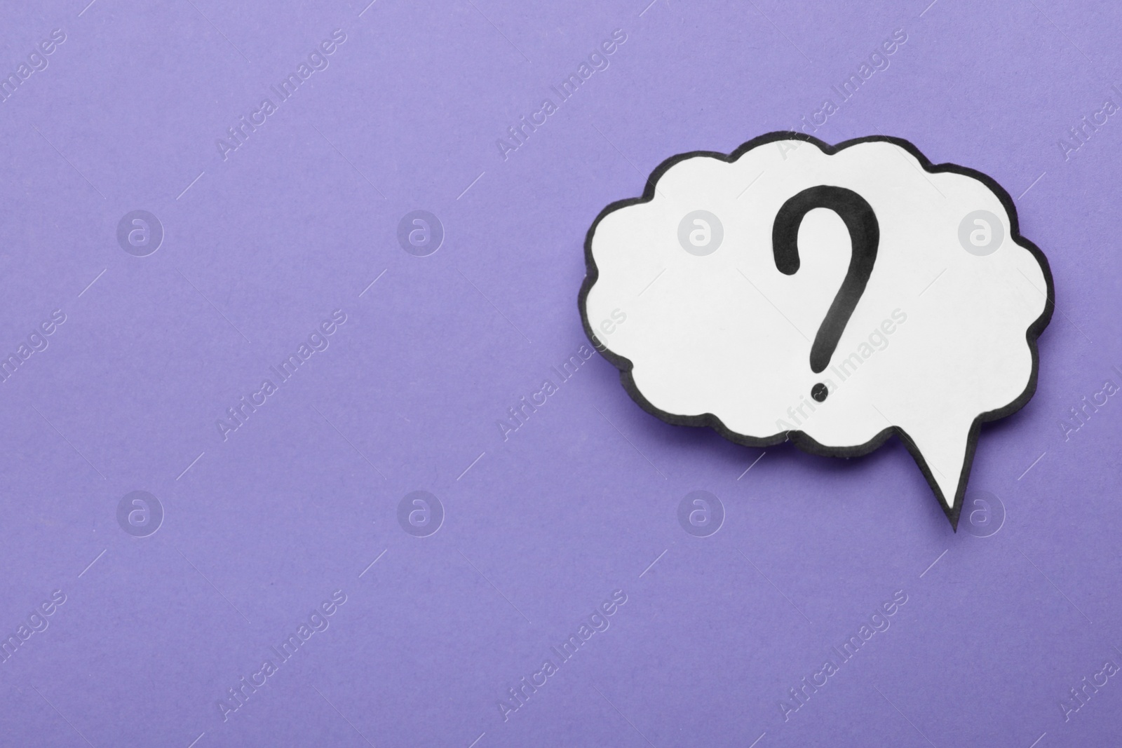 Photo of Paper speech bubble with question mark on violet background, top view. Space for text