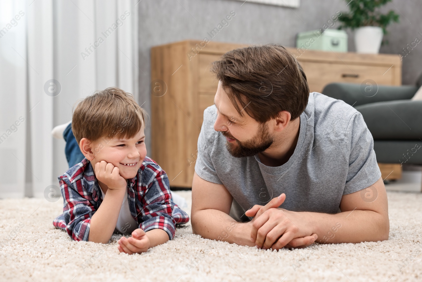 Photo of Family portrait of happy dad and son at home