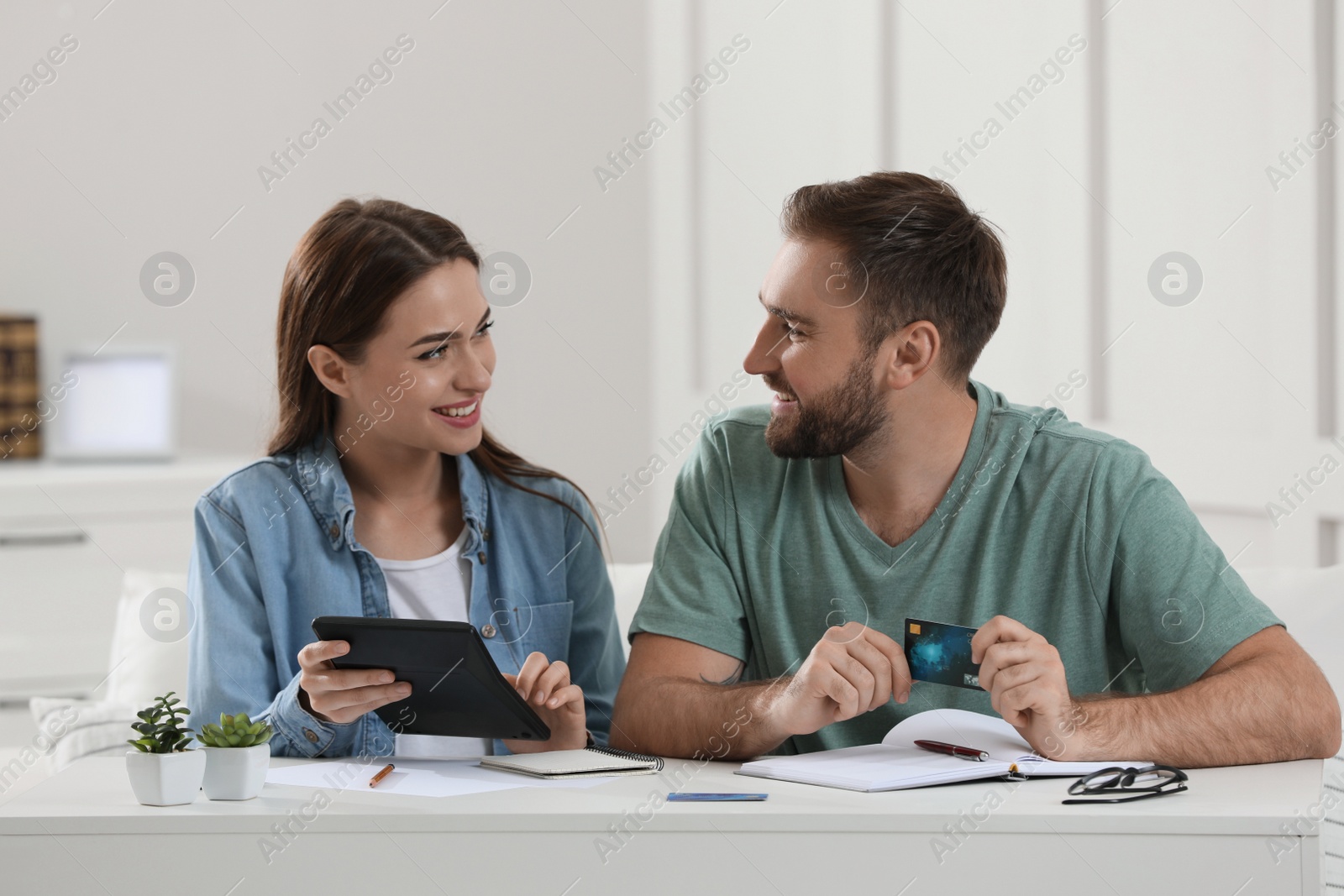 Photo of Young couple discussing family budget at home