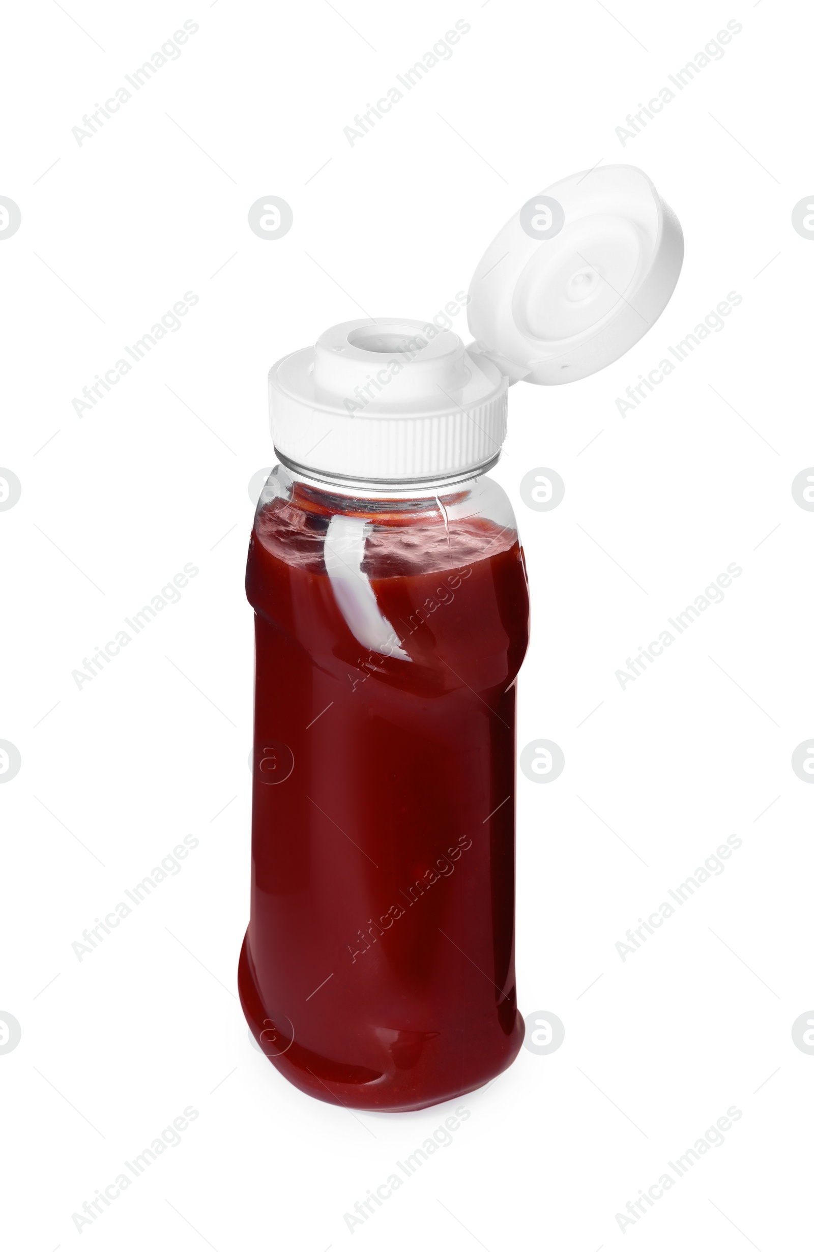 Photo of Bottle of tasty ketchup isolated on white