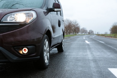 Photo of Car parked outdoors on rainy day