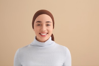 Smiling woman with cancer on beige background