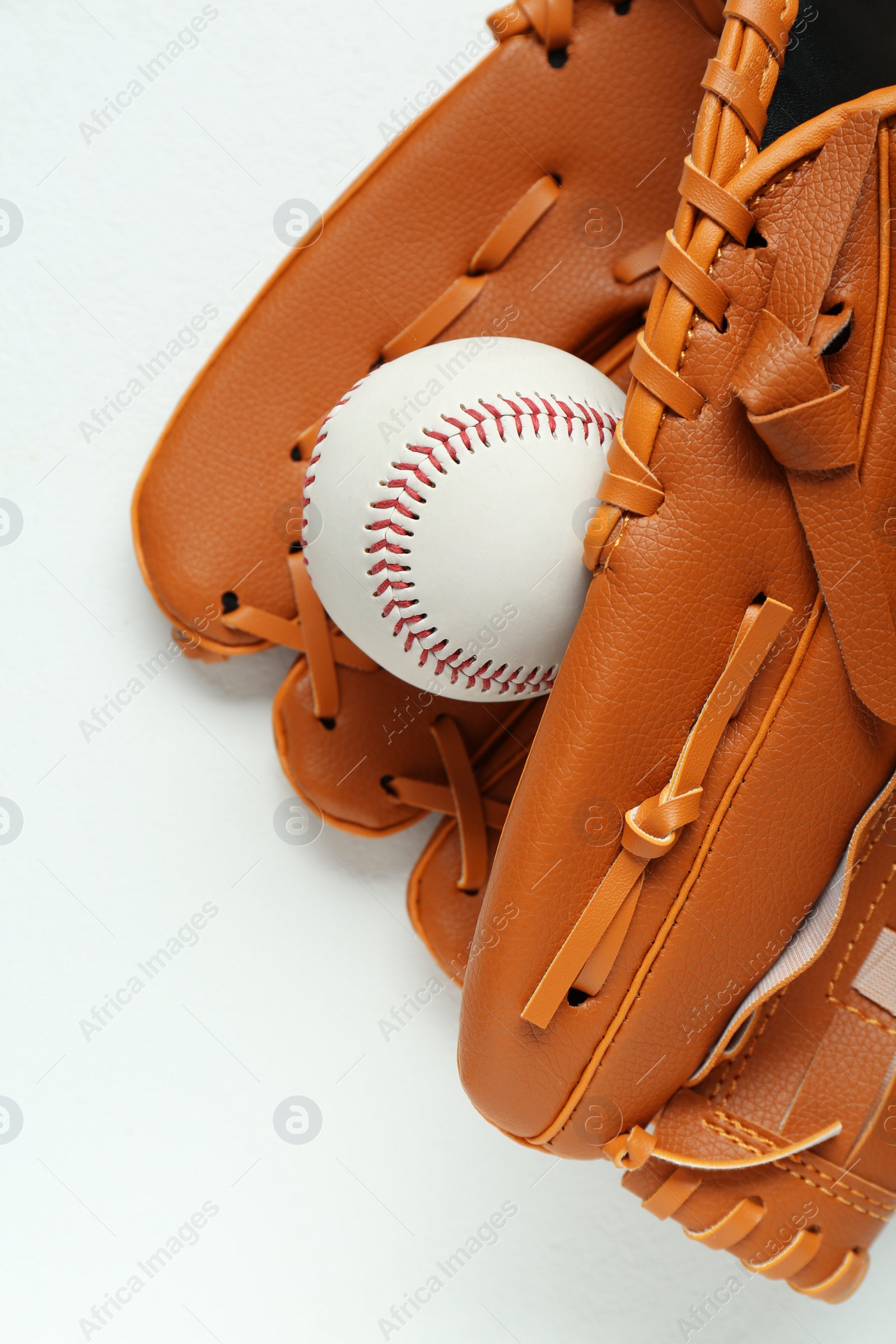 Photo of Catcher's mitt and baseball ball on white background, top view. Sports game