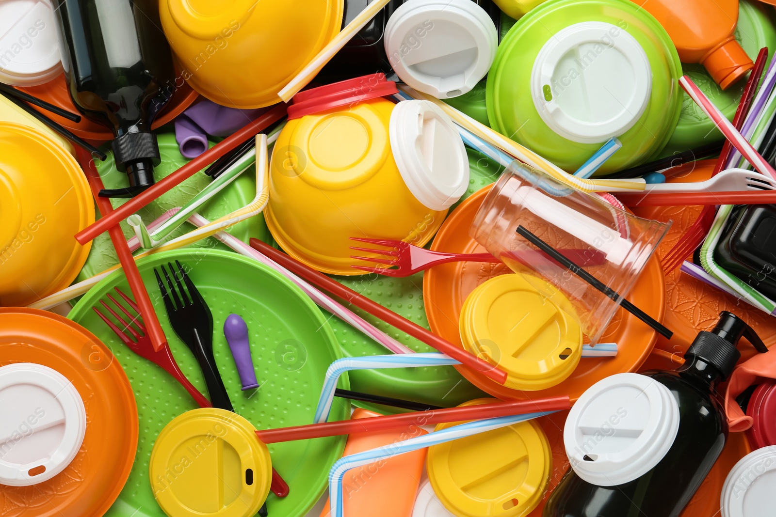 Photo of Different colorful plastic items as background, closeup