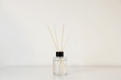 Photo of Aromatic reed air freshener on white table