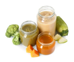 Photo of Jars with healthy baby food, broccoli, pumpkin and zucchini isolated on white