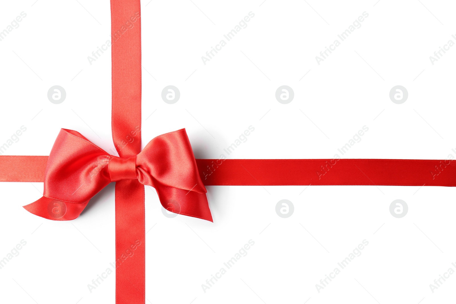 Photo of Red ribbon with bow on white background. Festive decoration