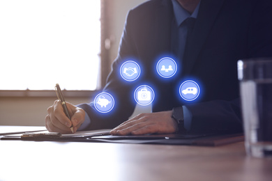 Businessman working at table in office, closeup. Insurance concept