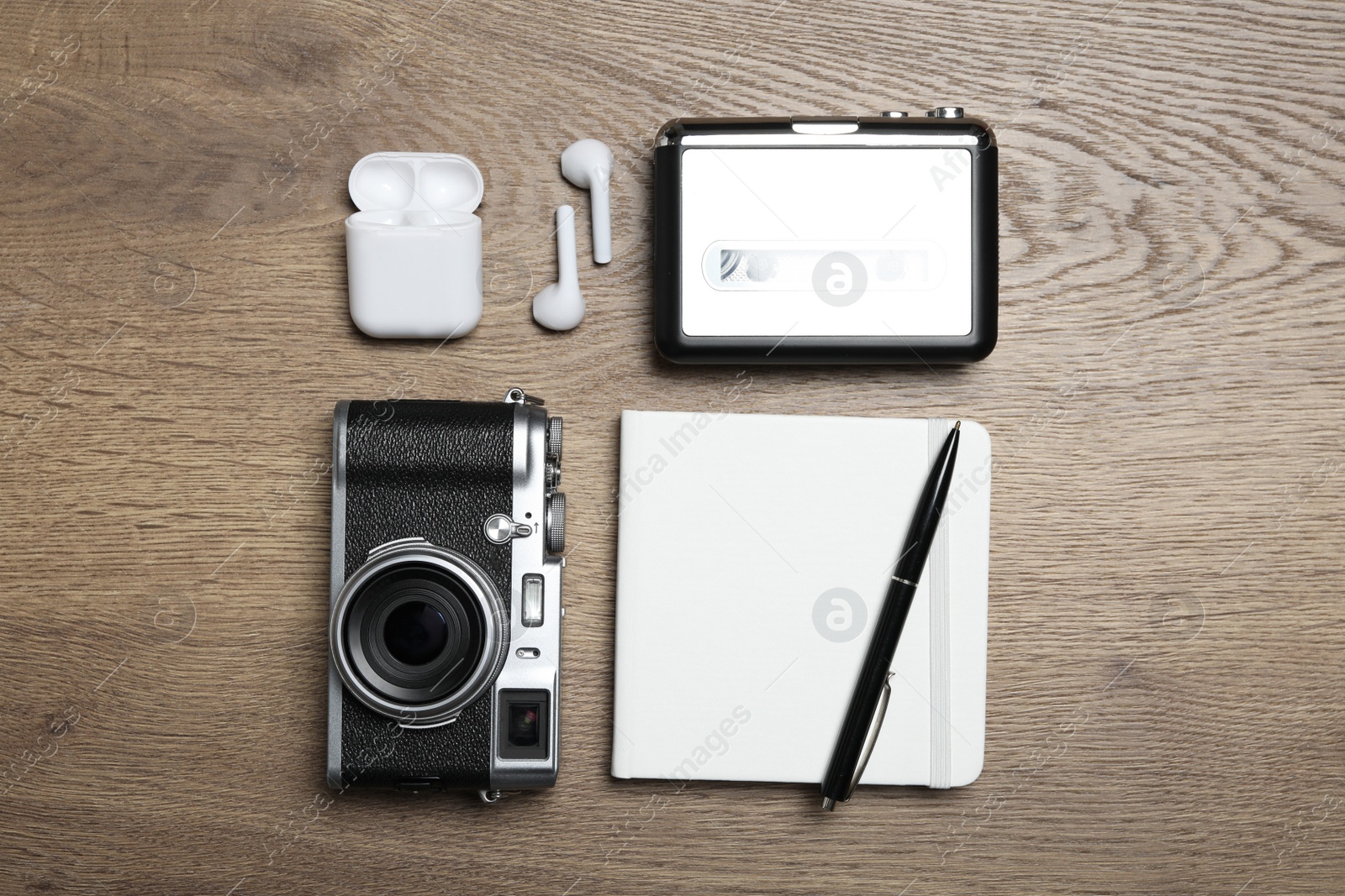 Photo of Flat lay composition with equipment for journalist on wooden table