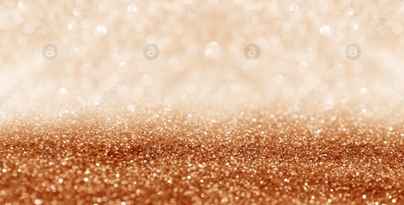 Image of Shiny orange glitter and blurred lights on background, banner design. Bokeh effect