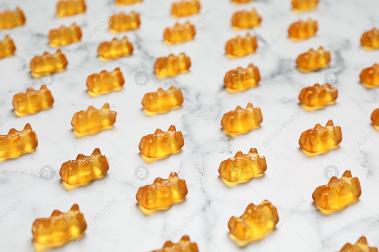 Photo of Delicious color little jelly bears on table