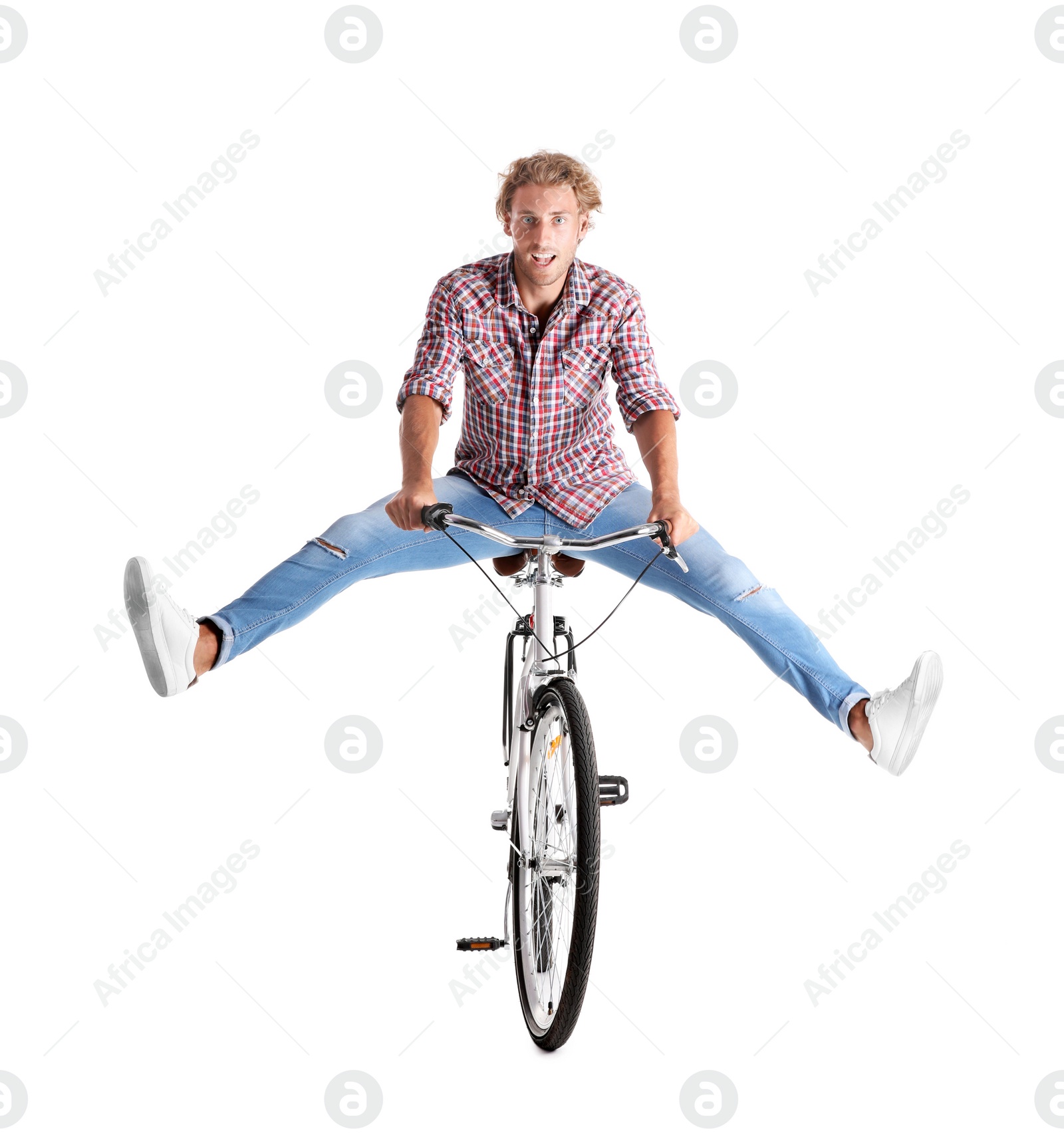 Photo of Handsome young man riding bicycle on white background