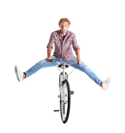 Handsome young man riding bicycle on white background