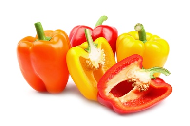 Photo of Whole and cut ripe bell peppers on white background