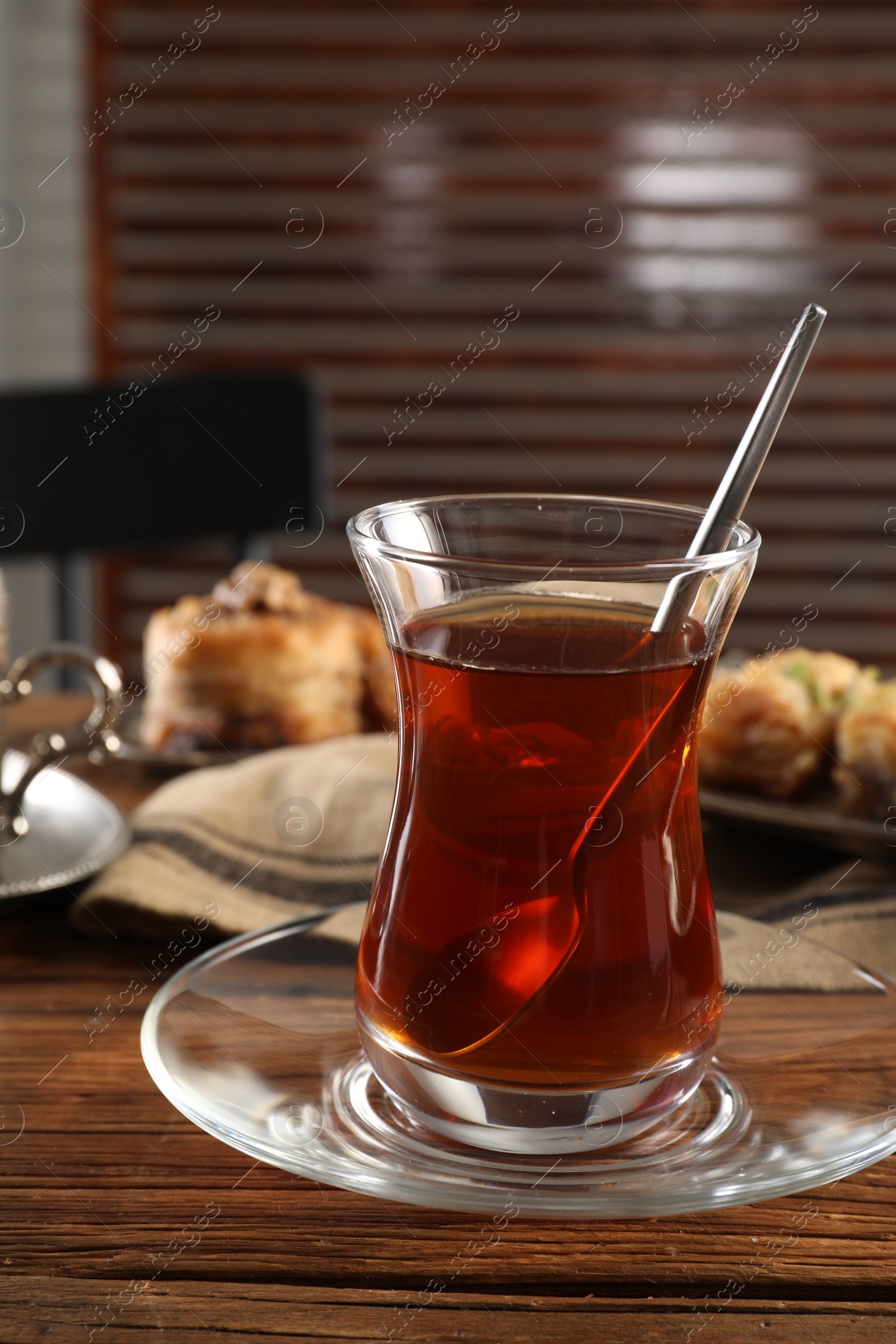 Photo of Traditional Turkish tea in glass on wooden table