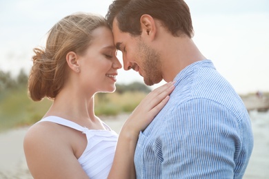 Happy young couple spending time at sea beach