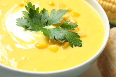 Photo of Delicious creamy corn soup in bowl, closeup