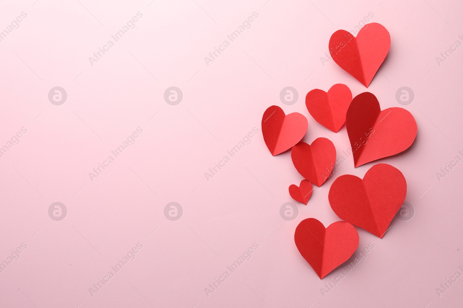 Photo of Paper hearts on pink background, flat lay. Space for text