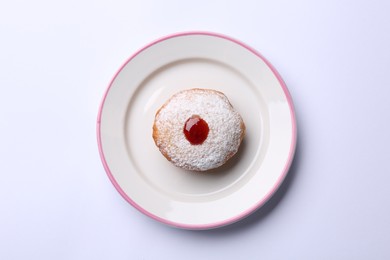 Photo of Hanukkah donut with jelly and powdered sugar on white background, top view