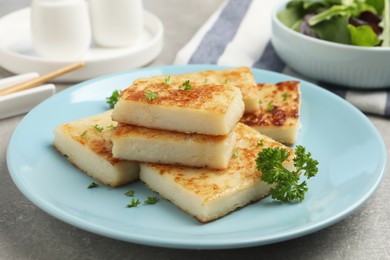 Delicious turnip cake with parsley served on grey table
