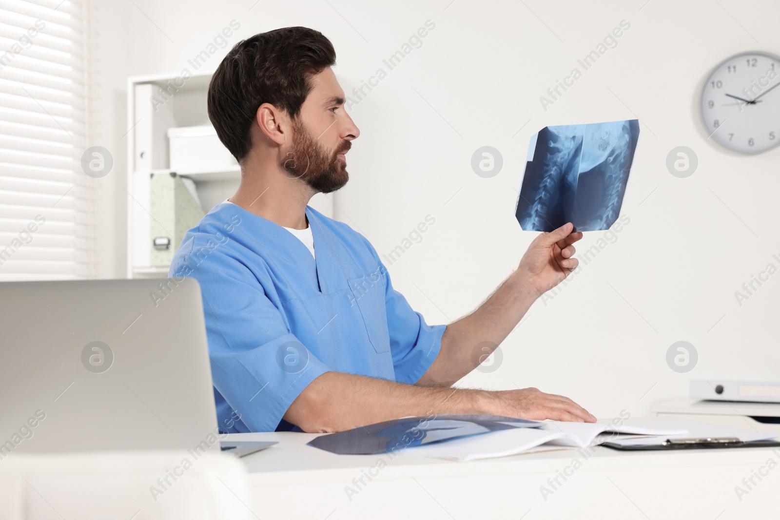 Photo of Doctor examining neck MRI scan in hospital