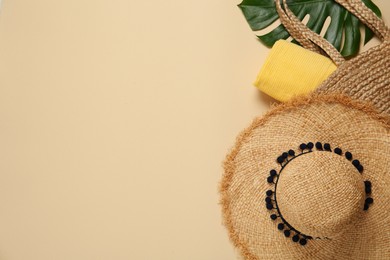 Photo of Flat lay composition with straw hat on beige background. Space for text