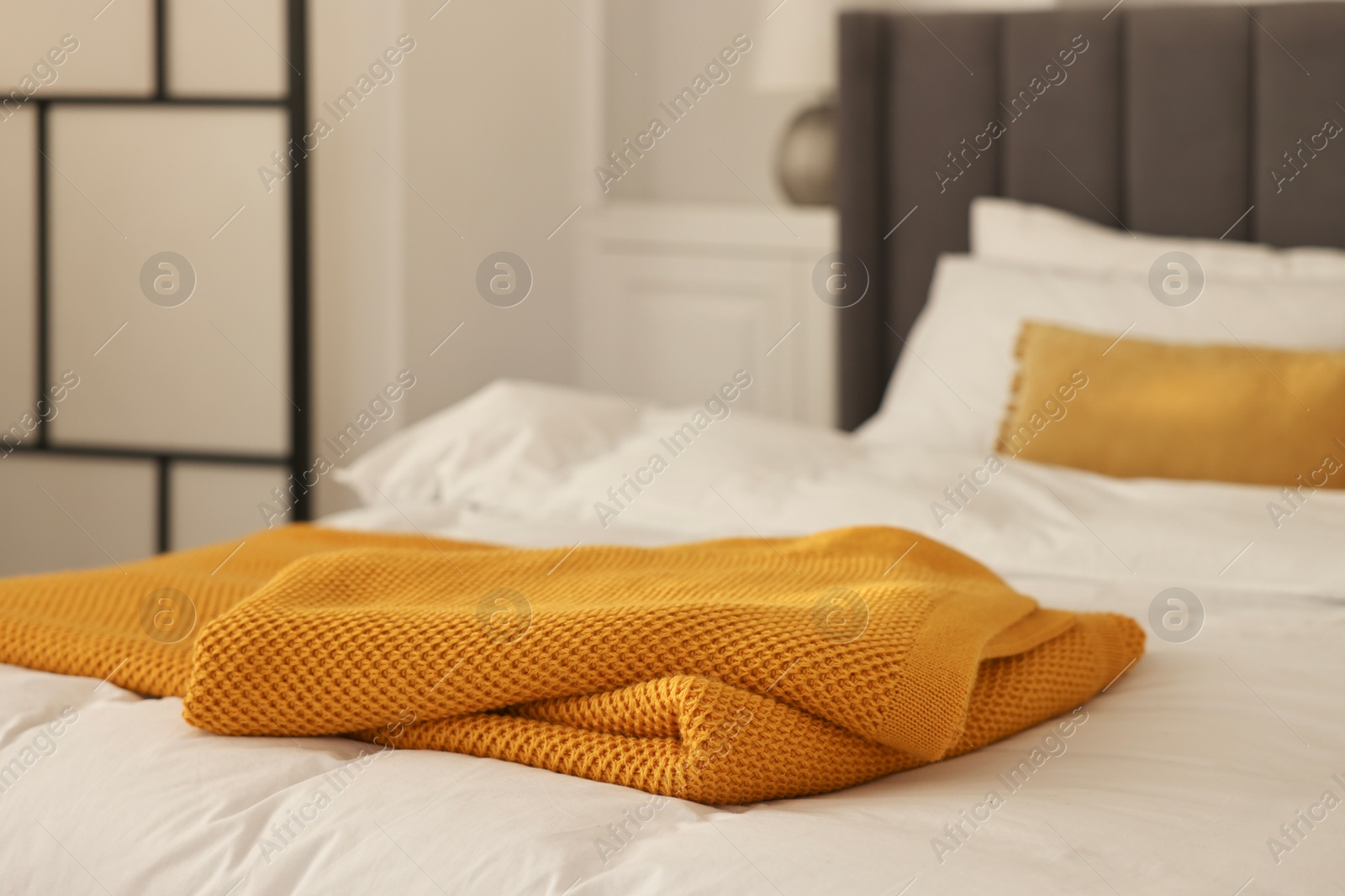 Photo of Soft orange plaid on bed in bedroom