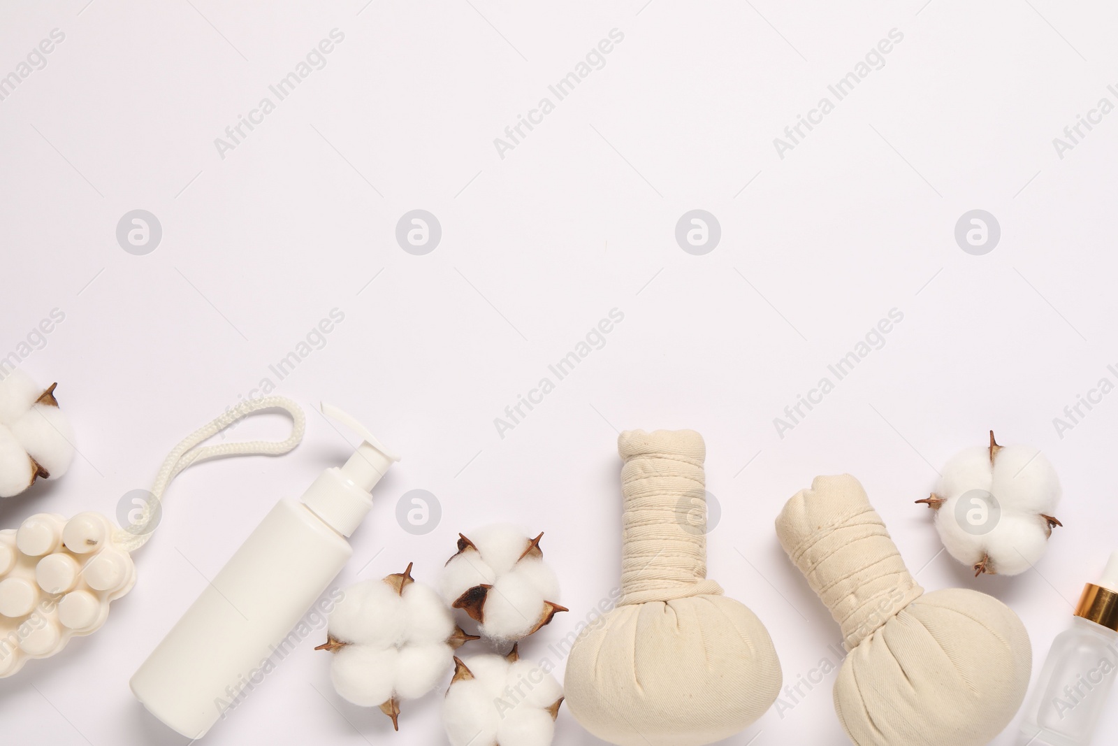 Photo of Bath accessories. Different personal care products and cotton flowers on white background, flat lay with space for text