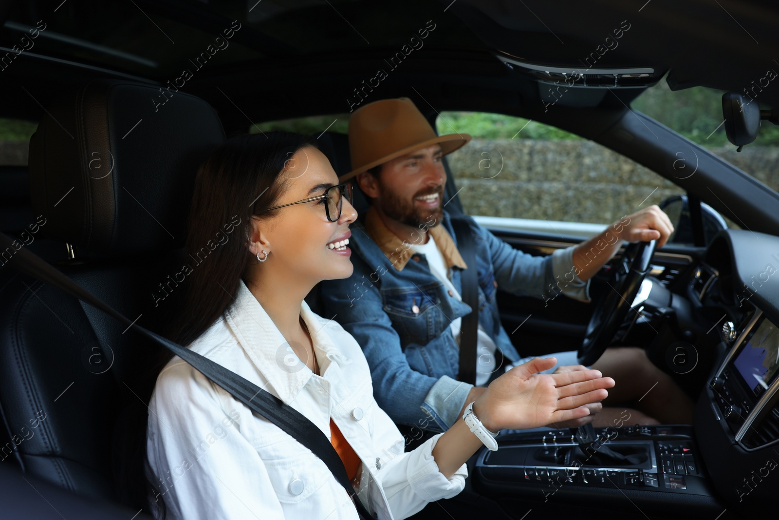 Photo of Happy couple enjoying trip together by car, selective focus