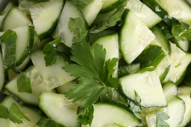 Delicious cucumber salad as background, top view