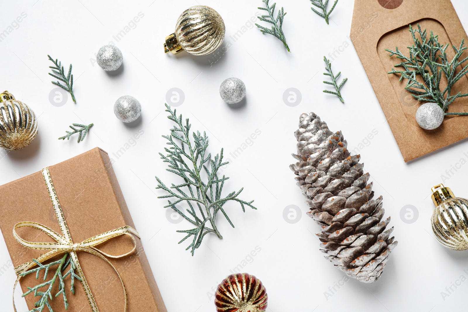 Photo of Flat lay composition with Christmas gift and festive decor on white background