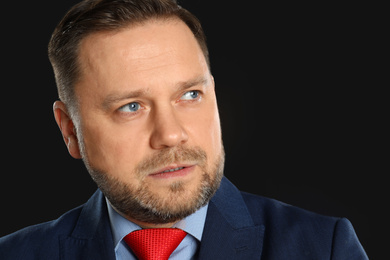 Photo of Portrait of mature man on black background