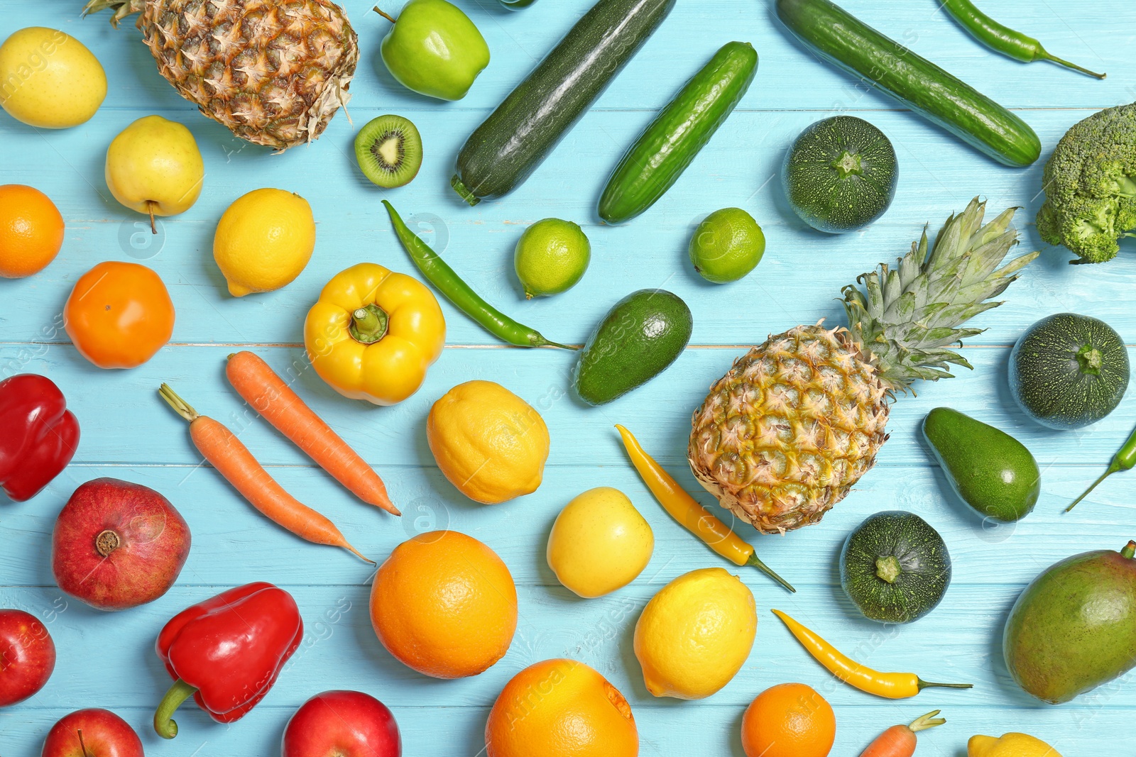 Photo of Rainbow collection of ripe fruits and vegetables on color background, top view