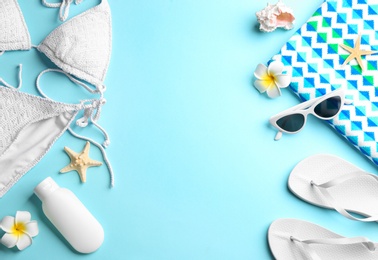 Flat lay composition with beach accessories on color background. Space for text