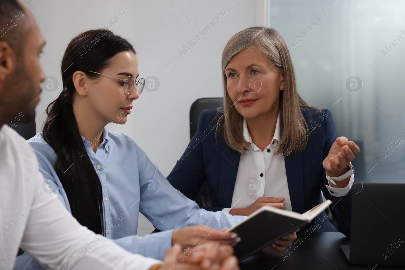 Photo of Lawyers working together at table in office