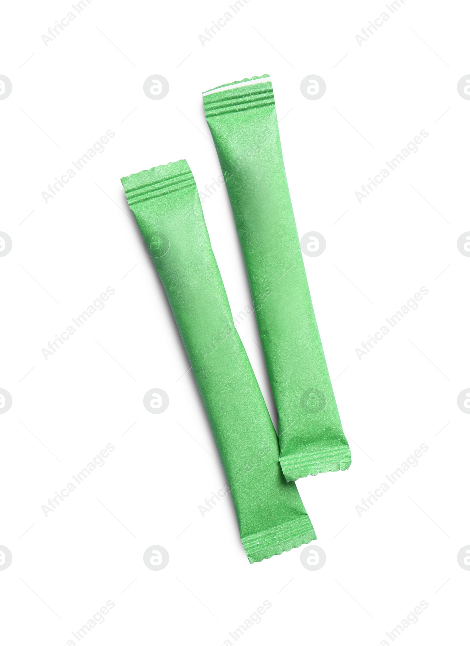 Photo of Green sticks of sugar on white background, top view