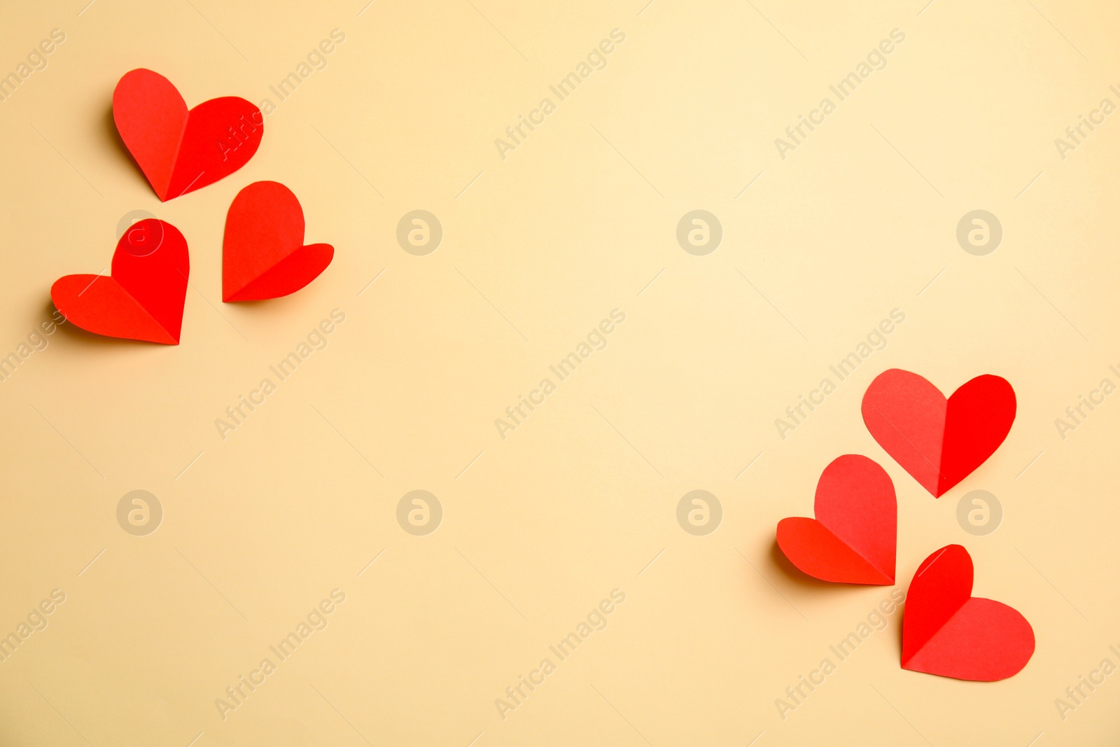 Photo of Small paper hearts on color background