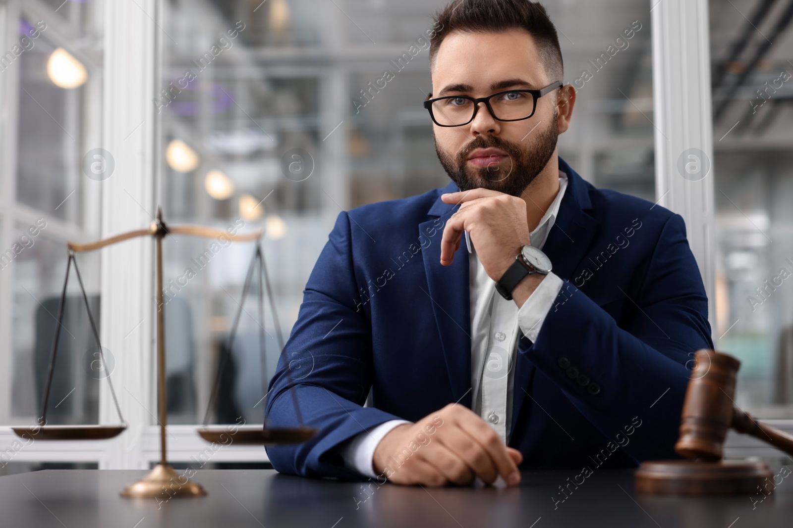 Photo of Portrait of handsome lawyer at table in office