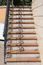 Beautiful tiled stairs with metal railings outdoors