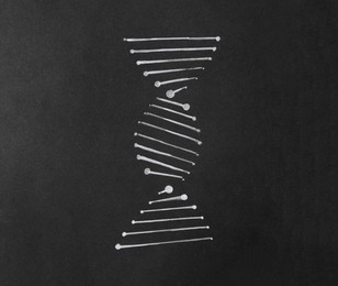 Photo of DrawingDNA molecular chain on black paper, top view