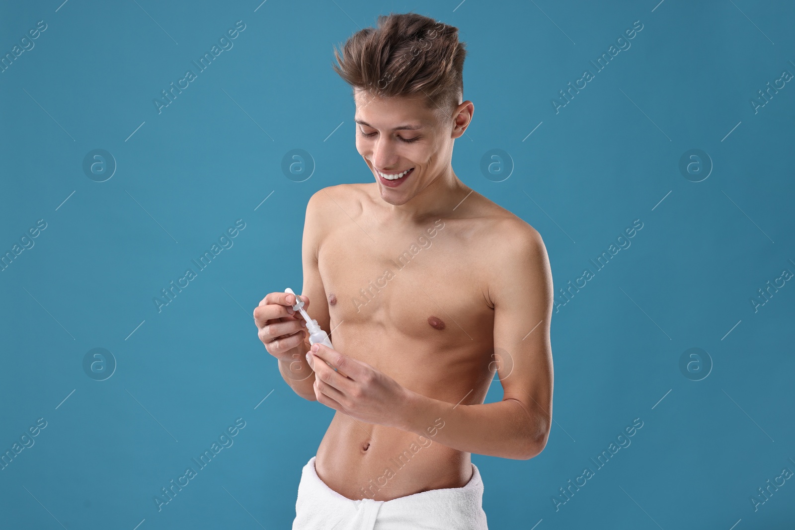 Photo of Handsome man with serum on blue background