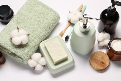 Bath accessories. Different personal care products and cotton flowers on white background