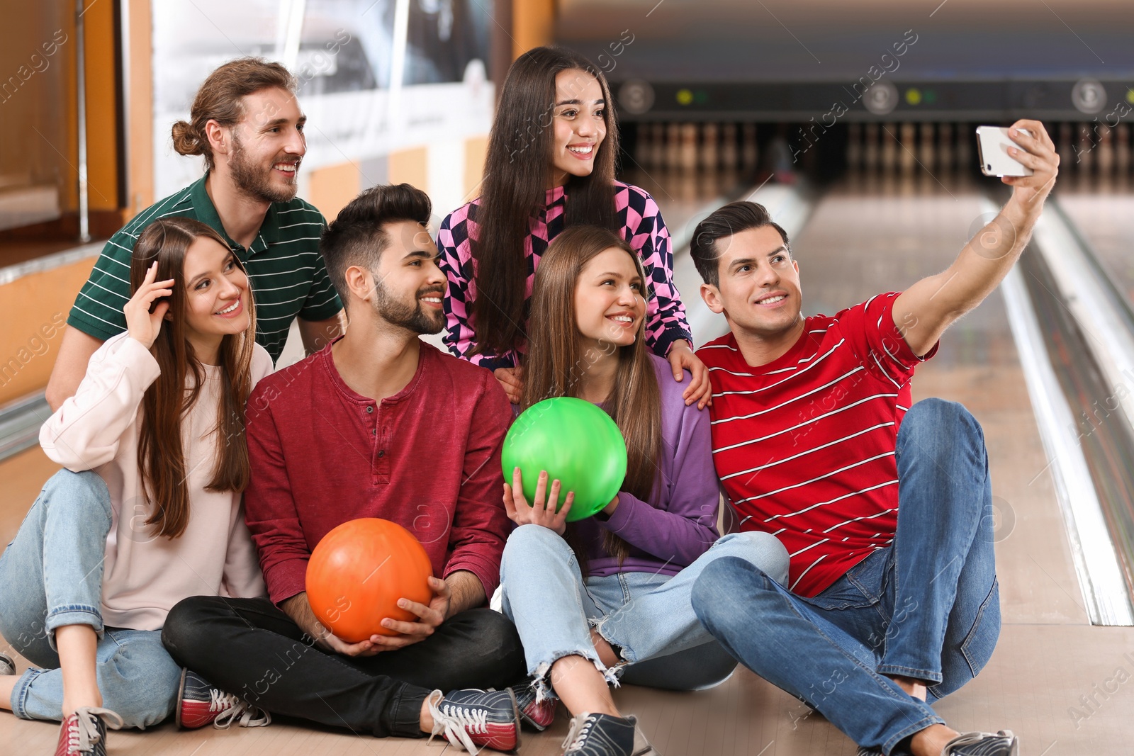 Photo of Group of friends taking selfie in bowling club