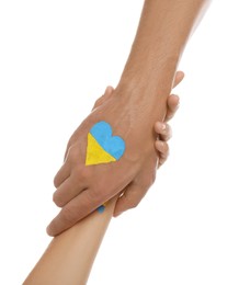 Woman and man with painted heart in colors of Ukrainian flag on his hand against white background, closeup