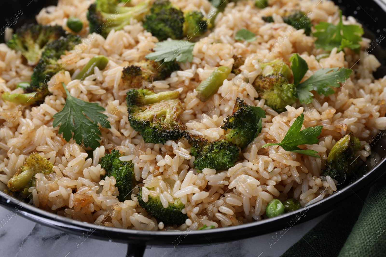 Photo of Tasty fried rice with vegetables on table, closeup