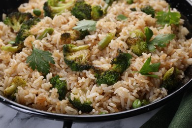 Tasty fried rice with vegetables on table, closeup