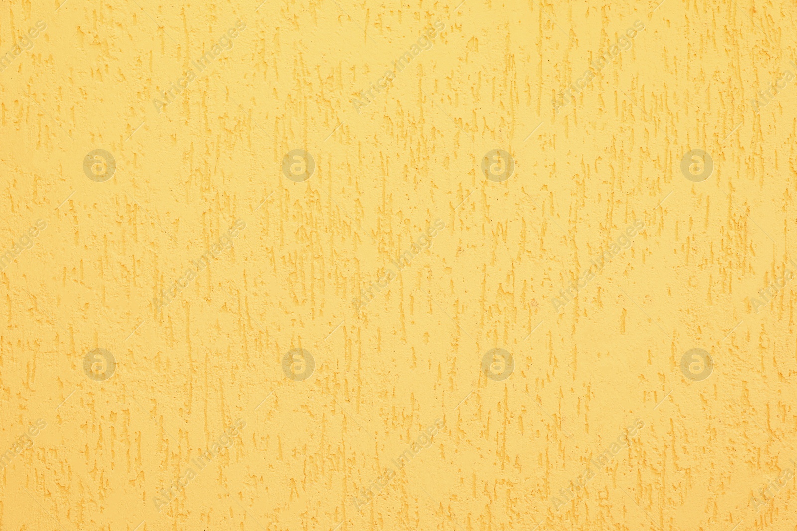 Photo of Texture of yellow plaster wall as background
