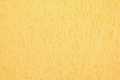 Photo of Texture of yellow plaster wall as background