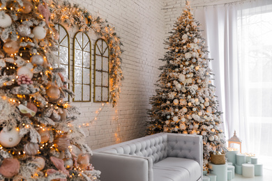 Photo of Beautiful interior of living room with decorated Christmas trees