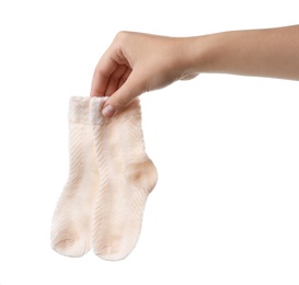 Photo of Woman holding pair of cute child socks on white background, closeup